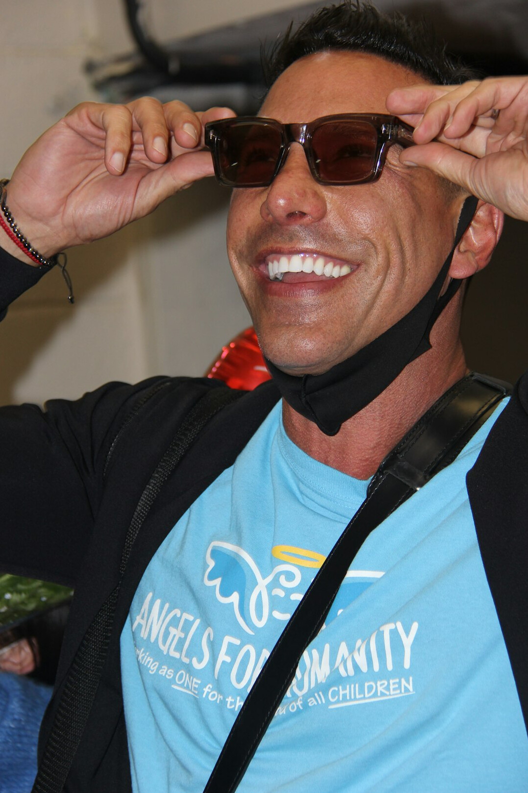 Studio portrait of a smiling brazilian man with glasses