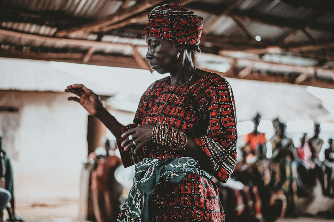 Woman speaking confidently to a group during a communication workshop