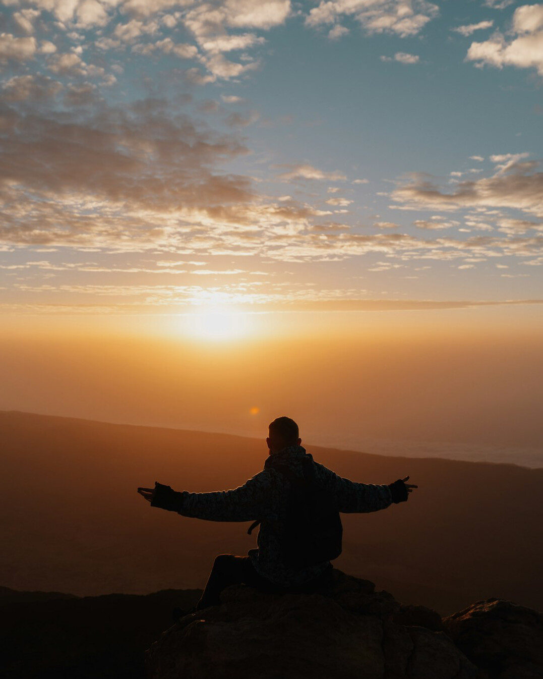 person meditating at sunrise