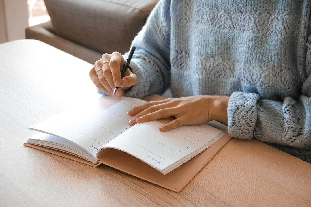 person journaling at desk