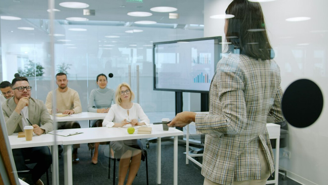 woman explaining idea to group